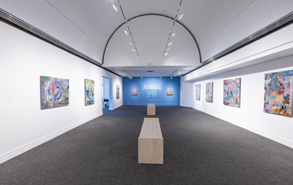 An installation view of an exhibition of paintings by Billy Bert Young in a vaulted gallery